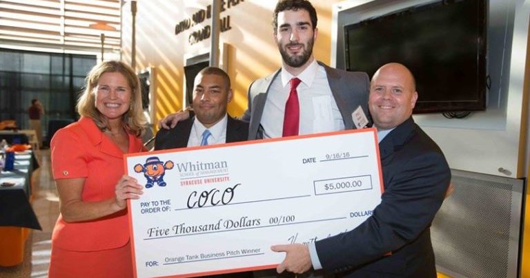 Orange Tank winners holding oversized check