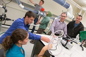Faculty member Cliff Davidson and lab students (taken pre-pandemic)