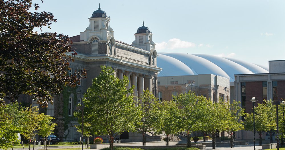 Carnegie Library and Carrier Dome during summer surrounded by green trees