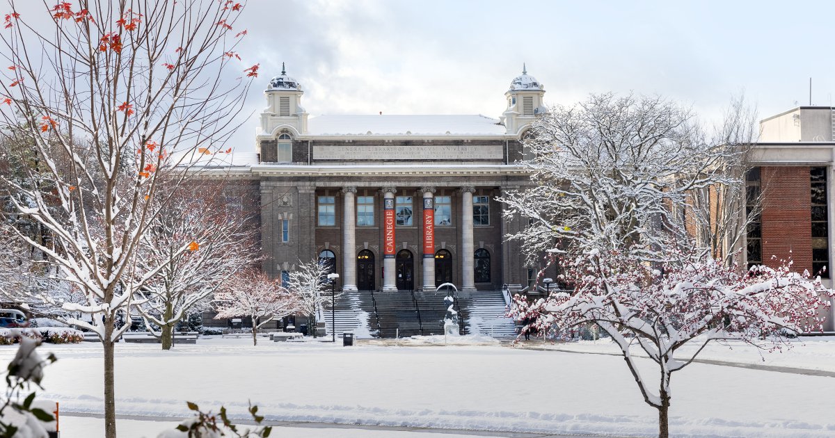 Carnegie library with snowy walkways and trees and cloudy sky