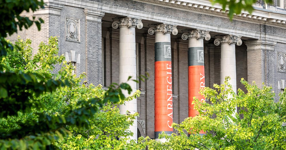 Carnegie Library surrounded by green leafy trees