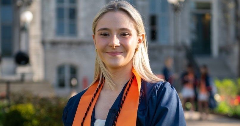 headshot of female in graduation gown in front of Hall of Languages