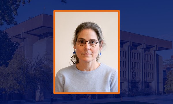 headshot of person with blue sepia of library in background