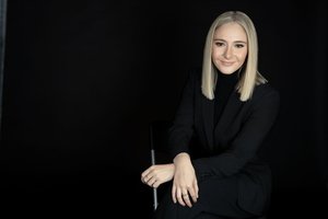 Catherine Forrest in black suit poses for a headshot