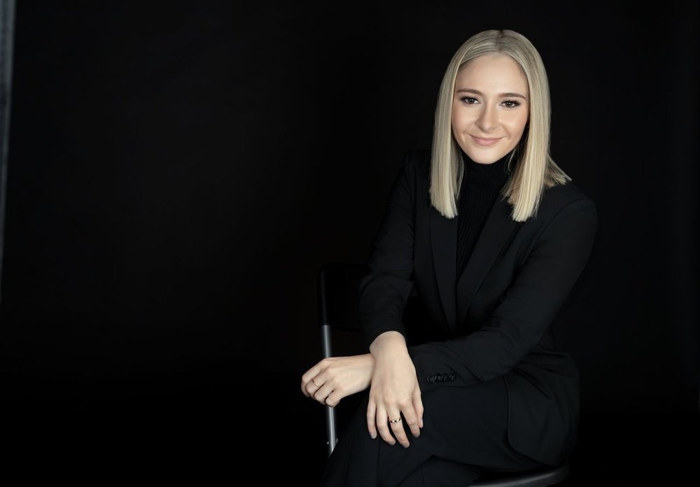 Catherine Forrest in black suit poses for a headshot