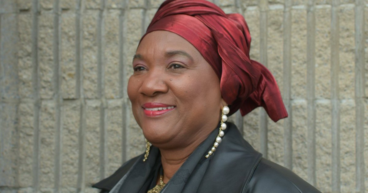 Black woman headshot with red wrap around her head