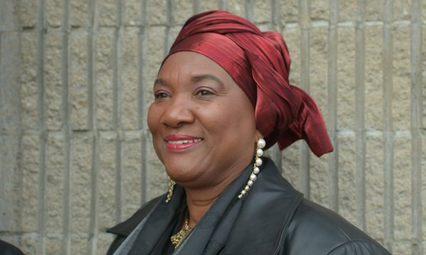 Black woman headshot with red wrap around her head