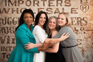 four women hugging each other