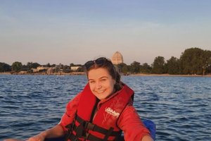 student in a life vest on a canal in Venice