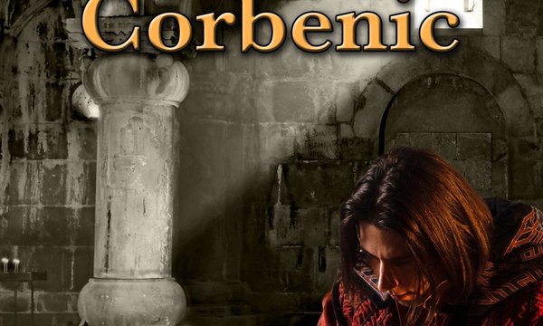 medieval man sitting in castle reading piece of paper with candle on table