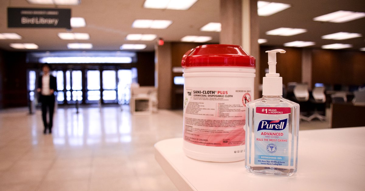 White desk with hand sanitizer and sanitizing wipes in Bird Library during the COVID-19 pandemic