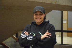 Female student in a cap smiling at camera
