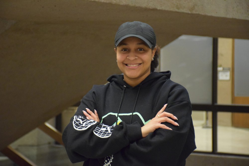Female student in a cap smiling at camera