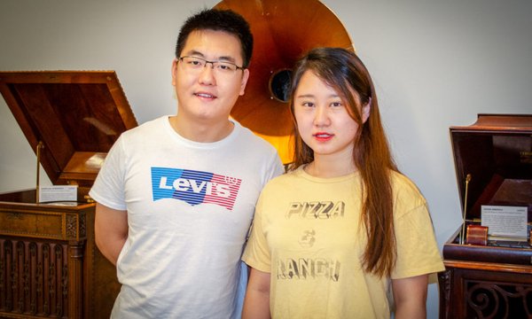 Two graduate students standing together in Belfer Audio Archives