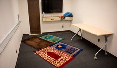 room with prayer rugs on floor