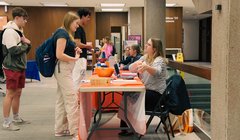 people tabling in Bird with students standing at tables