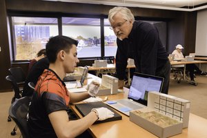 Prof. James Watts working with student in Special Collections