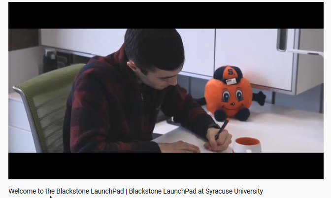 student writing on his notebook