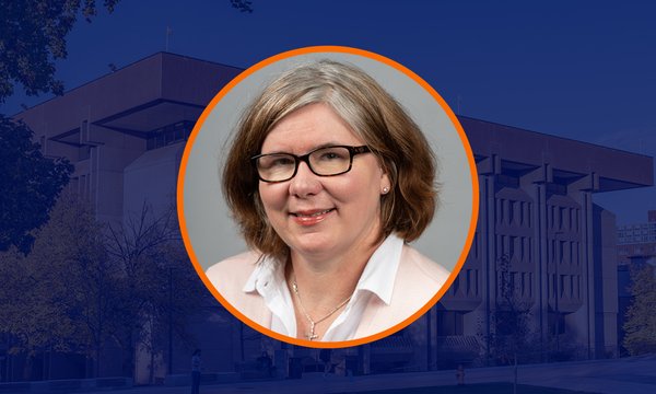 Circular portrait of Déirdre Joyce with orange outline over dark blue overlaid image of Bird Library