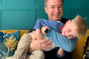 Derek Wallace hugging his son