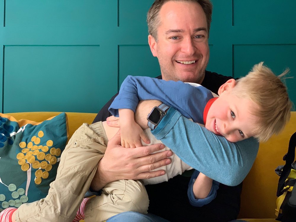 Derek Wallace hugging his son