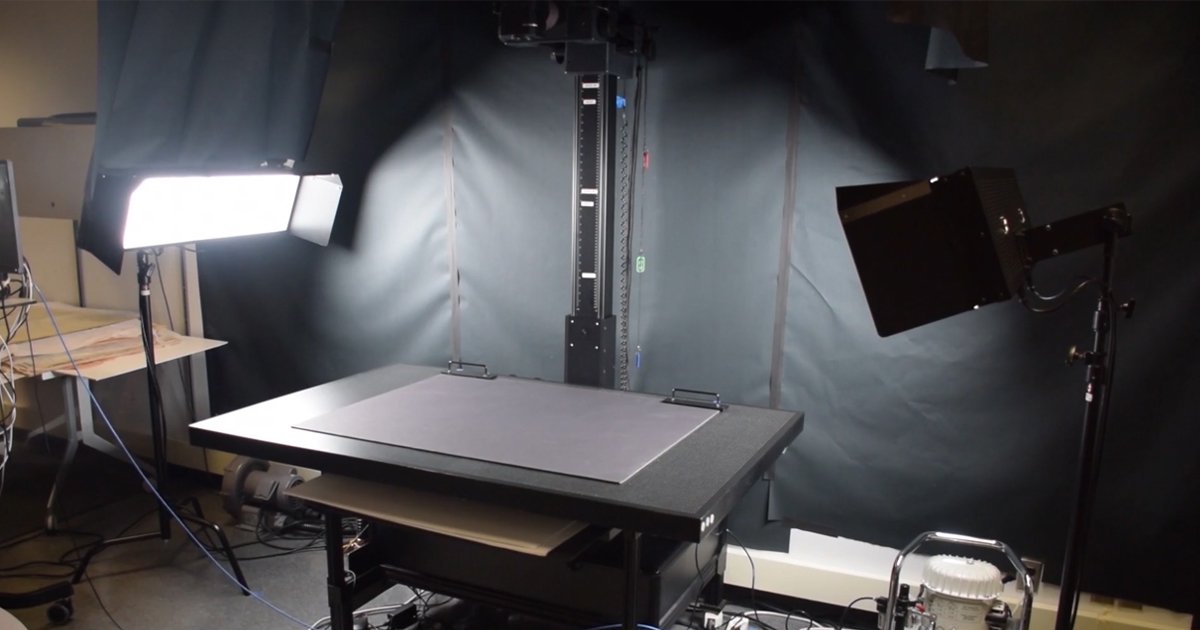 Flat black surface with black backdrop, lighting and overhead camera for digitization of documents