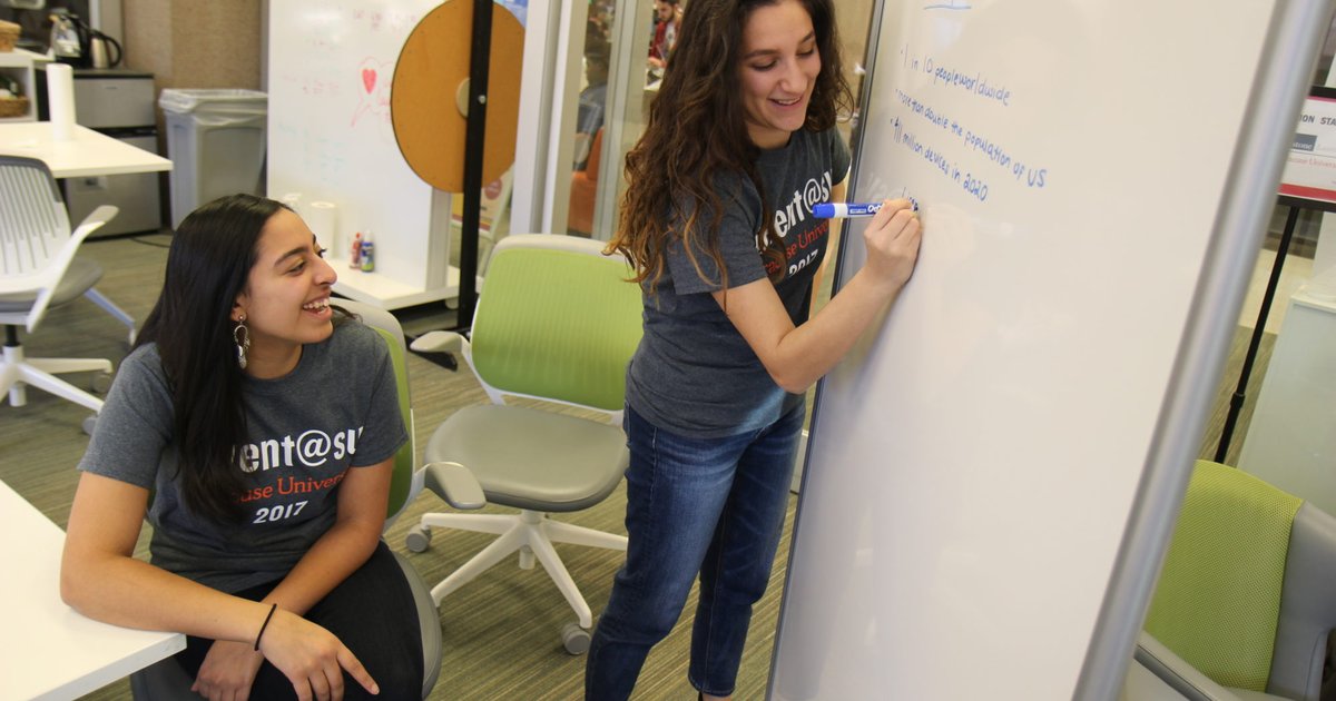 students writing on the whiteboard