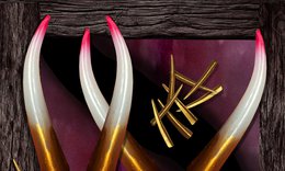 four 3-dimensional pink, white and gold horn shapes overlapping with 8 small gold horns scattered between them
