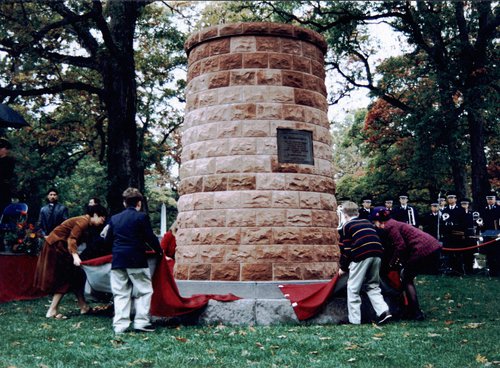 Family members of the victims of the Pan Am Flight 103 bombing unveil the inscribed base of the Lockerbie Memorial Cairn at the 3 November 1995 dedication ceremony. Thomas Britton Schultz Family Papers.