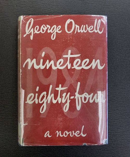 First printing of the First British Edition. The book has its original light green cloth and is protected by its red dust jacket.