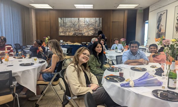 students sitting at tables as part of Founders Circle dinner
