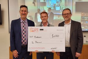 Scott Warren, Syracuse University Libraries (left) and Bruce Kingma, School of Information Studies (right) present check to Ben Ford ’23 (Martin J. Whitman School of Management), founder of Fundwurx