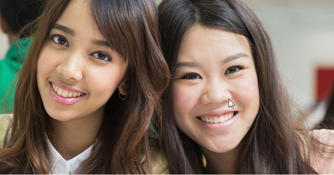 2 female students smiling at the camera
