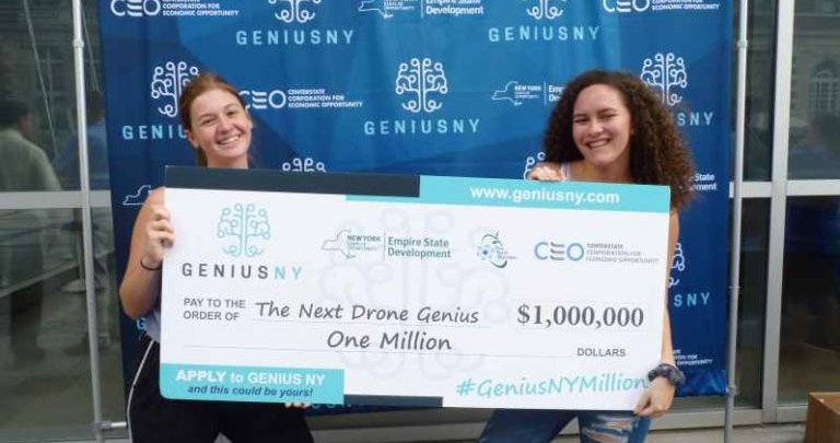 two female holding GeniusNY award check