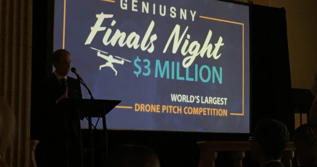 man on stage at Genius NY