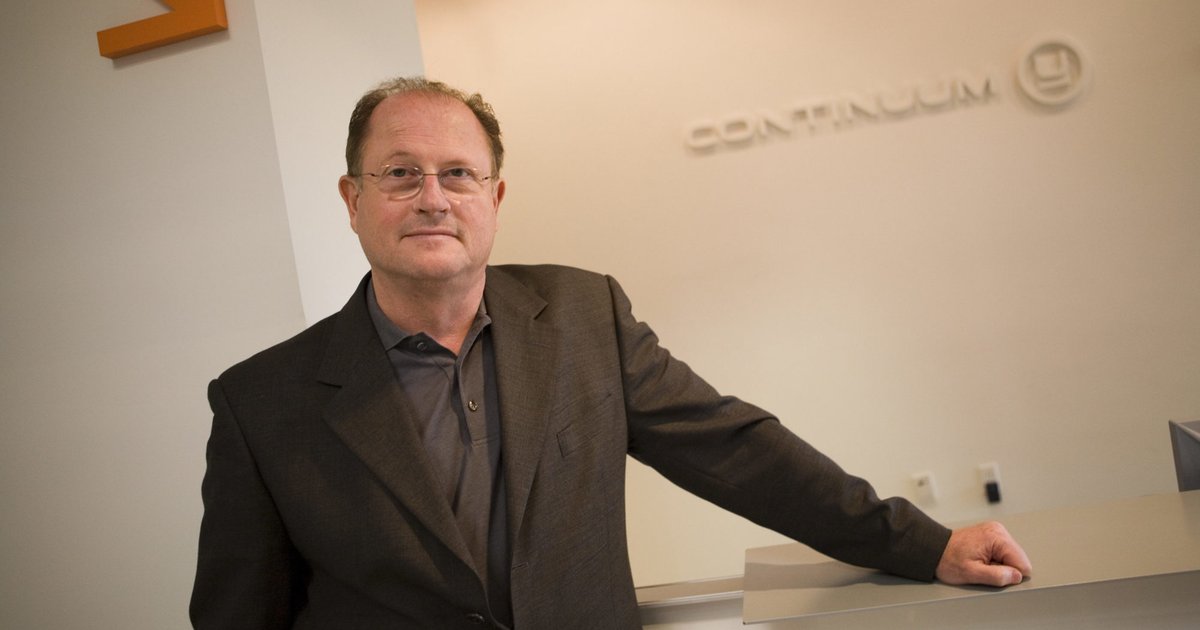 man in front of continuum sign