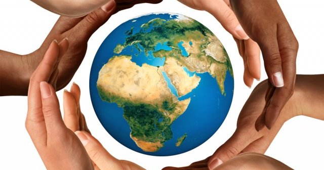 photo of hands around a globe