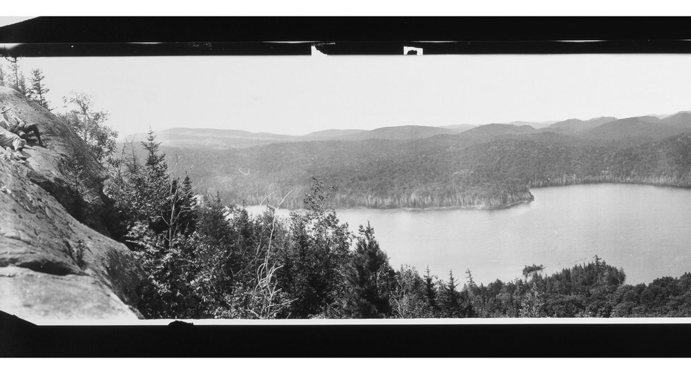 black and white photo of Adirondack Mountains and lake