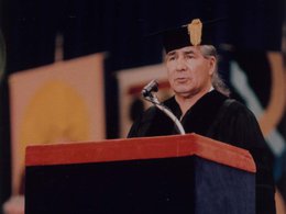 Oren Lyons in cap and gown behind podium at the 1993 Syracuse University commencement