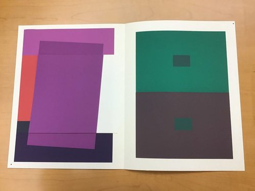 Purple and green blocks on white paper.