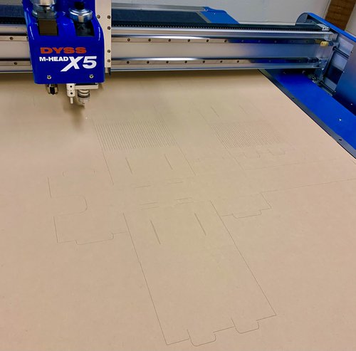 box cutter cutting out beige box