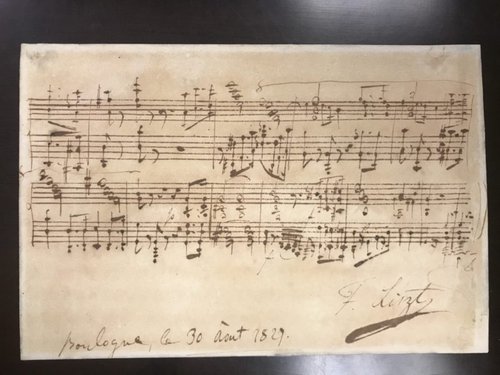 Handwritten music on parchment paper.