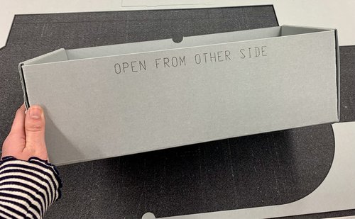 gray box with words "open from other side" printed on top
