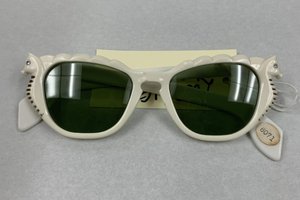 Pair of white sunglasses with seahorses on the sides of the lenses.