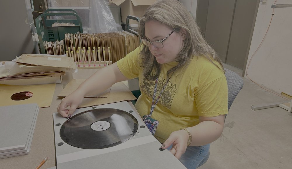 person working with lacquer disc at work table