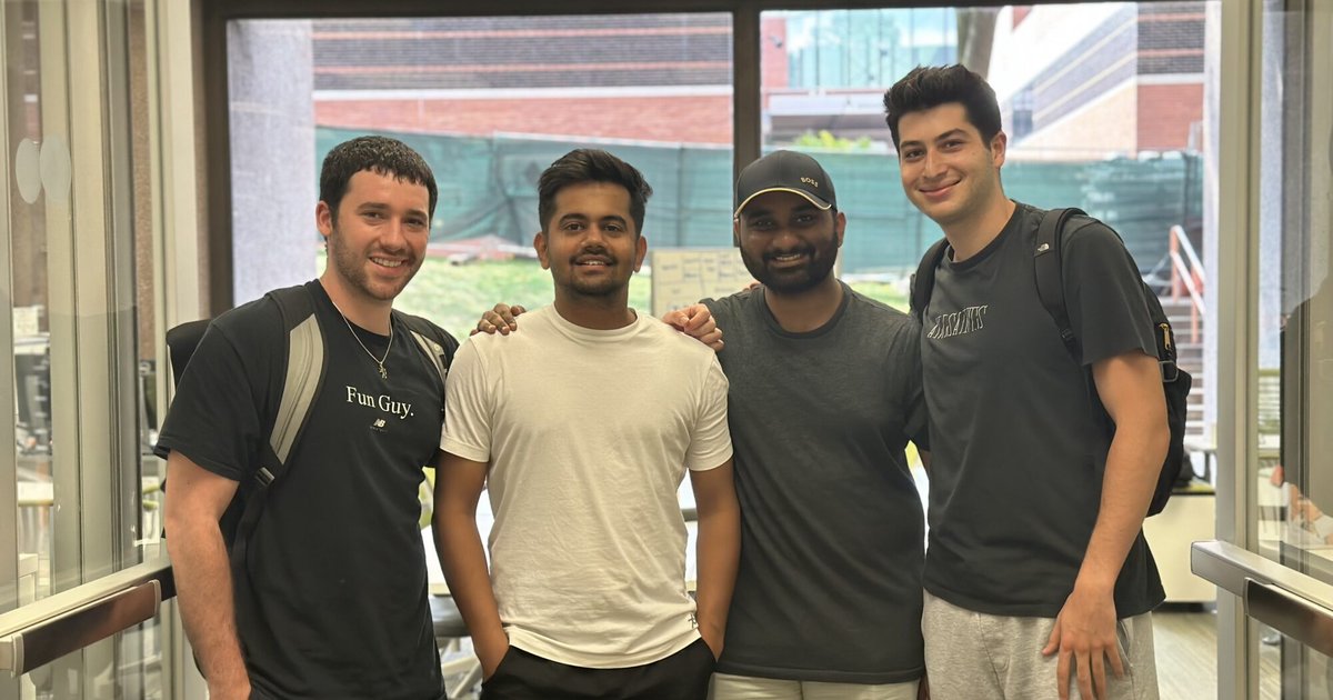 4 male students pose for a photo at the Blackstone LaunchPad office