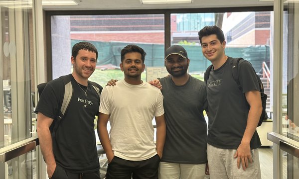 4 male students pose for a photo at the Blackstone LaunchPad office