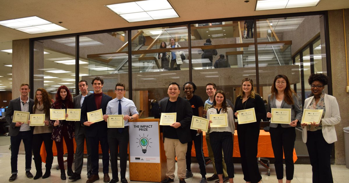 row of students standing with oversized checks in their hands