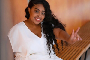 woman in white dress doing the peace sign