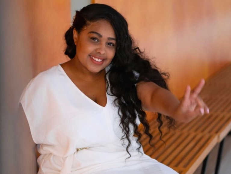 woman in white dress doing the peace sign